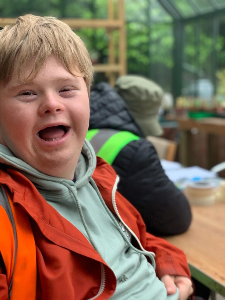 Euan, from Watch US Grow, is wearing his gardening gear and smiling at the camera.